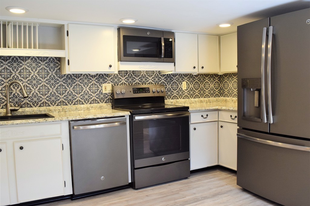 110 Horton Road Orange, MA 01364 - Photo 4 of 30 a kitchen with a stove and a refrigerator
