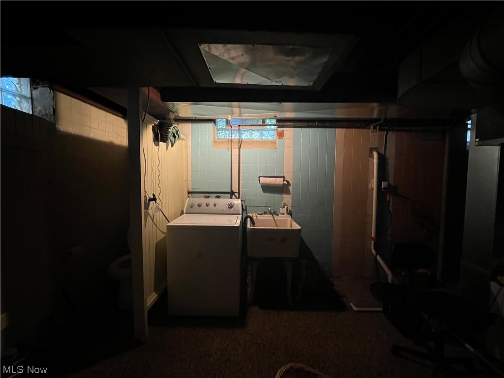 3835 Covington Road Cleveland, OH 44121 - Photo 22 of 34 Basement with dark carpet, washer / clothes dryer, and sink