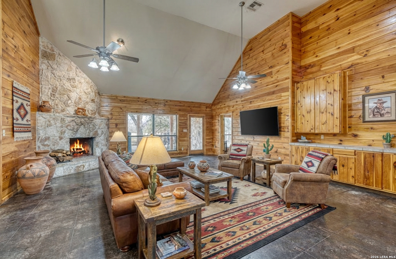 498 Camino Del Rancho Concan, TX 78838 - Photo 12 of 49 a living room with furniture a flat screen tv and a fireplace