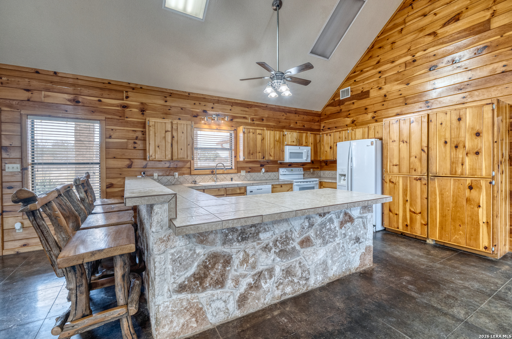 498 Camino Del Rancho Concan, TX 78838 - Photo 14 of 49 a living room with stainless steel appliances kitchen island granite countertop furniture and a large window