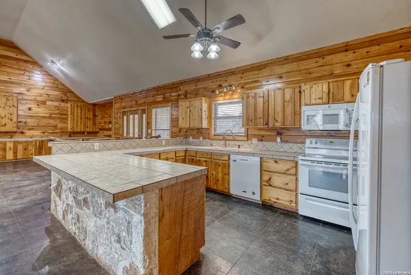 a kitchen that has a lot of cabinets in it and stainless steel appliances