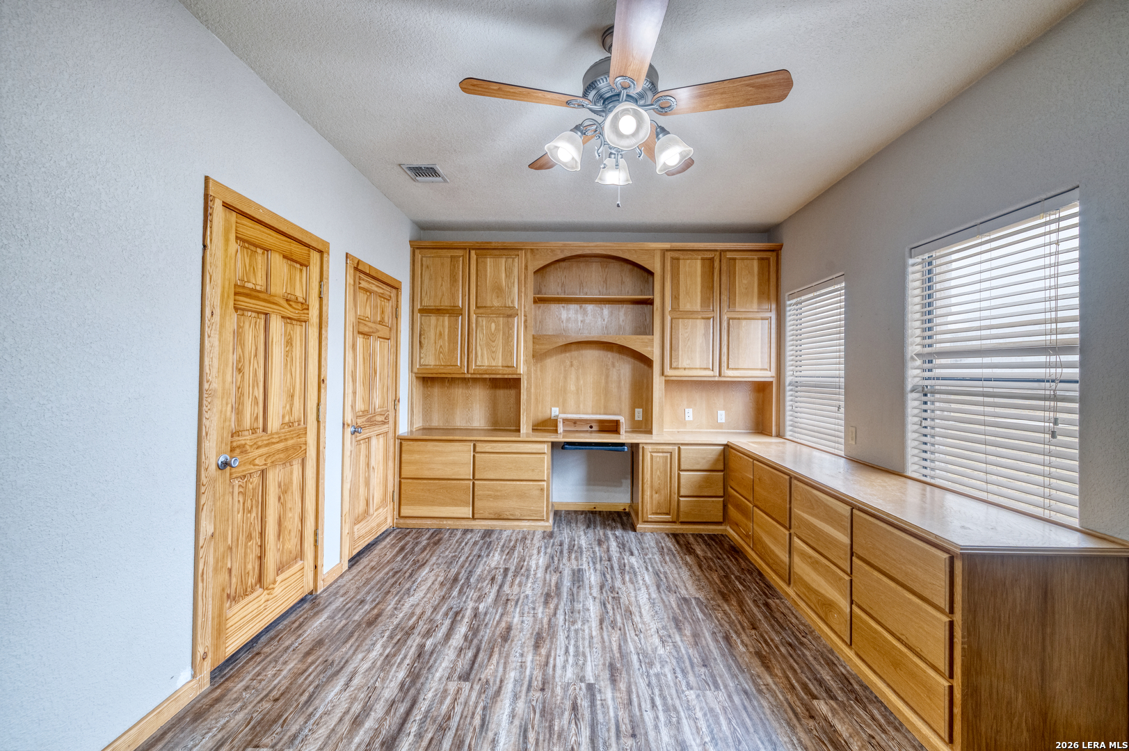 498 Camino Del Rancho Concan, TX 78838 - Photo 25 of 49 a large kitchen with a wooden floor and stainless steel appliances