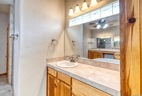 a bathroom with a sink a vanity and a mirror