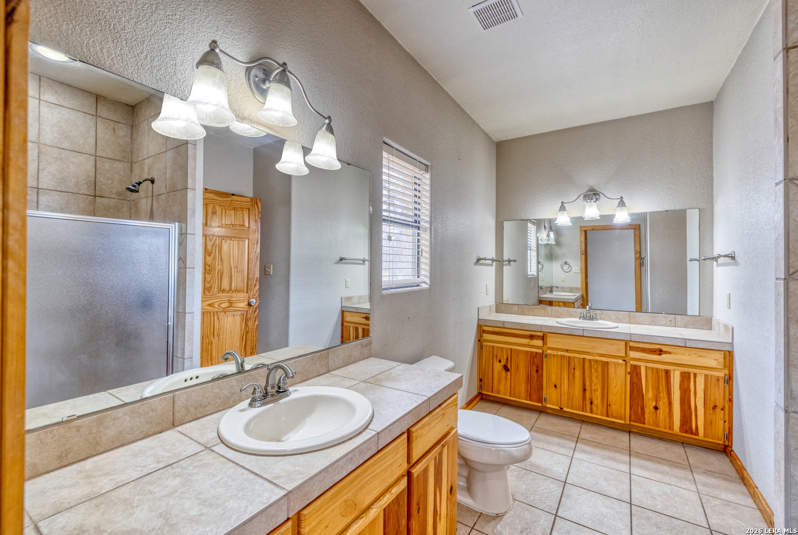 498 Camino Del Rancho Concan, TX 78838 - Photo 29 of 49 a bathroom with a granite countertop sink and a mirror