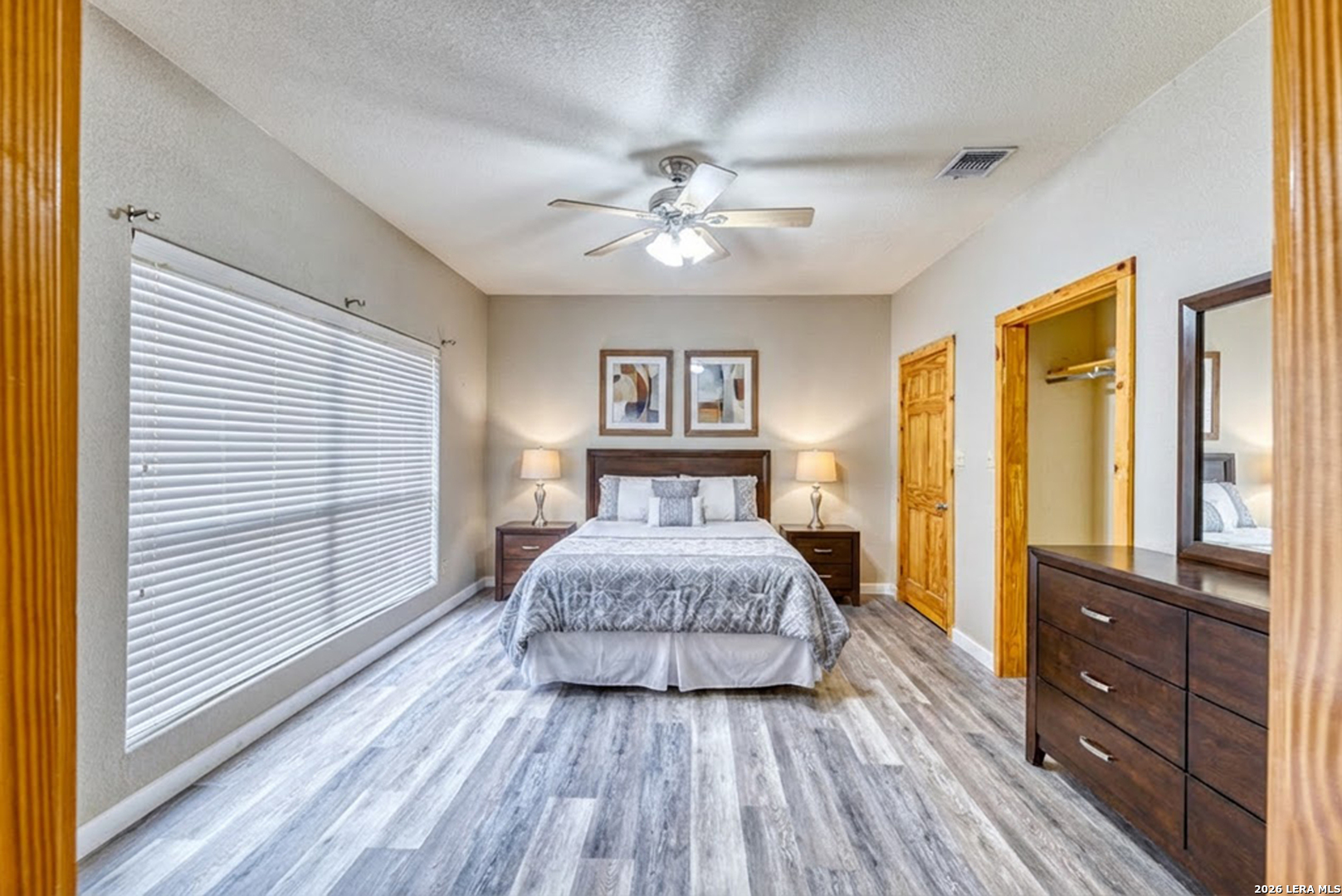 498 Camino Del Rancho Concan, TX 78838 - Photo 31 of 49 a spacious bedroom with a bed and wooden floor
