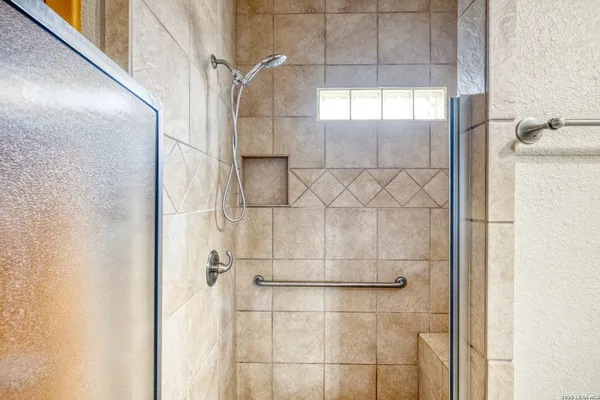 a bathroom with a glass shower door