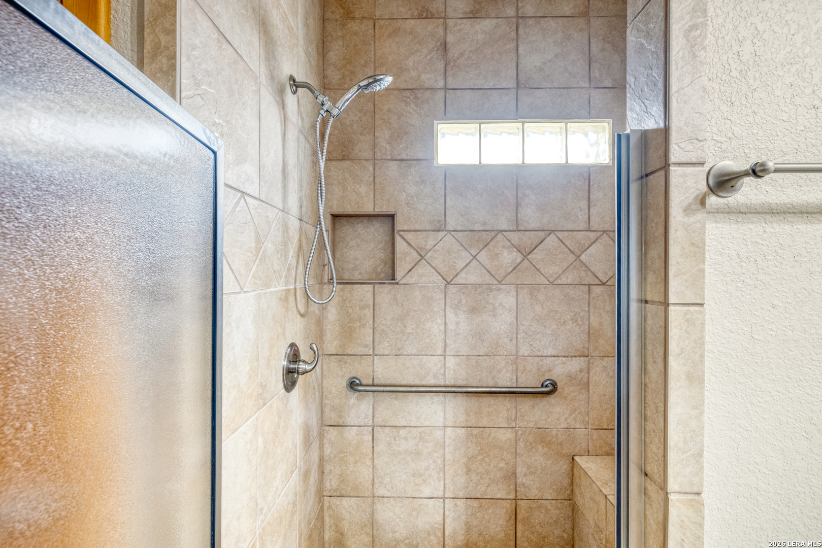 498 Camino Del Rancho Concan, TX 78838 - Photo 32 of 49 a bathroom with a glass shower door