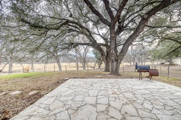 a backyard of a house with large trees