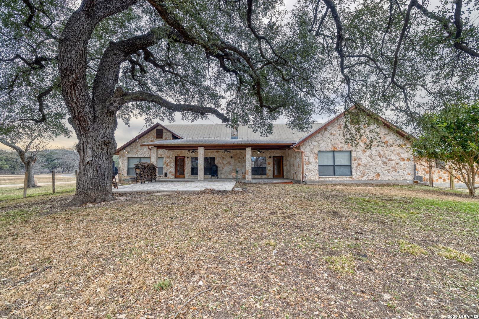 498 Camino Del Rancho Concan, TX 78838 - Photo 36 of 49 a front view of a house with a yard and large trees