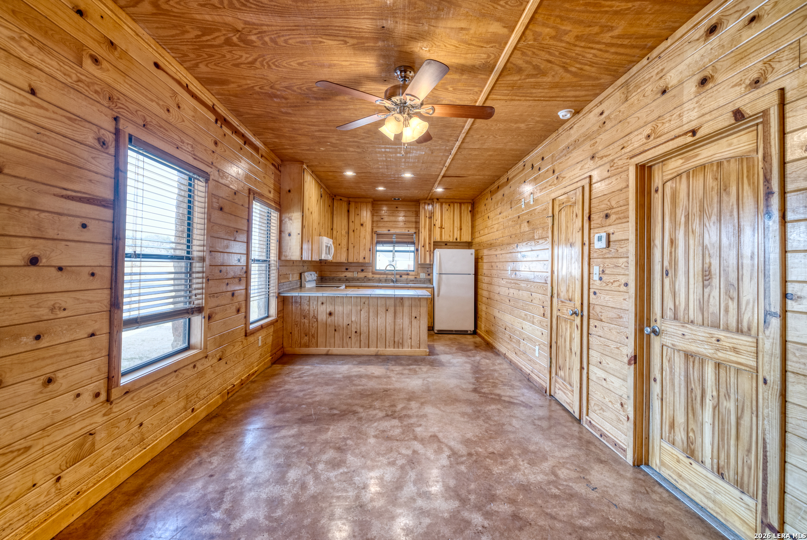 498 Camino Del Rancho Concan, TX 78838 - Photo 39 of 49 a view of a hallway with the cabinet and chandelier