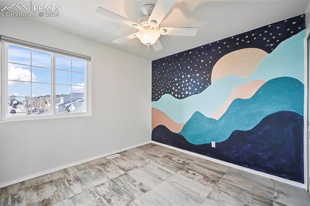 10165 Angeles Road Peyton, CO 80831 - Photo 28 of 38 Unfurnished room with ceiling fan and light tile floors