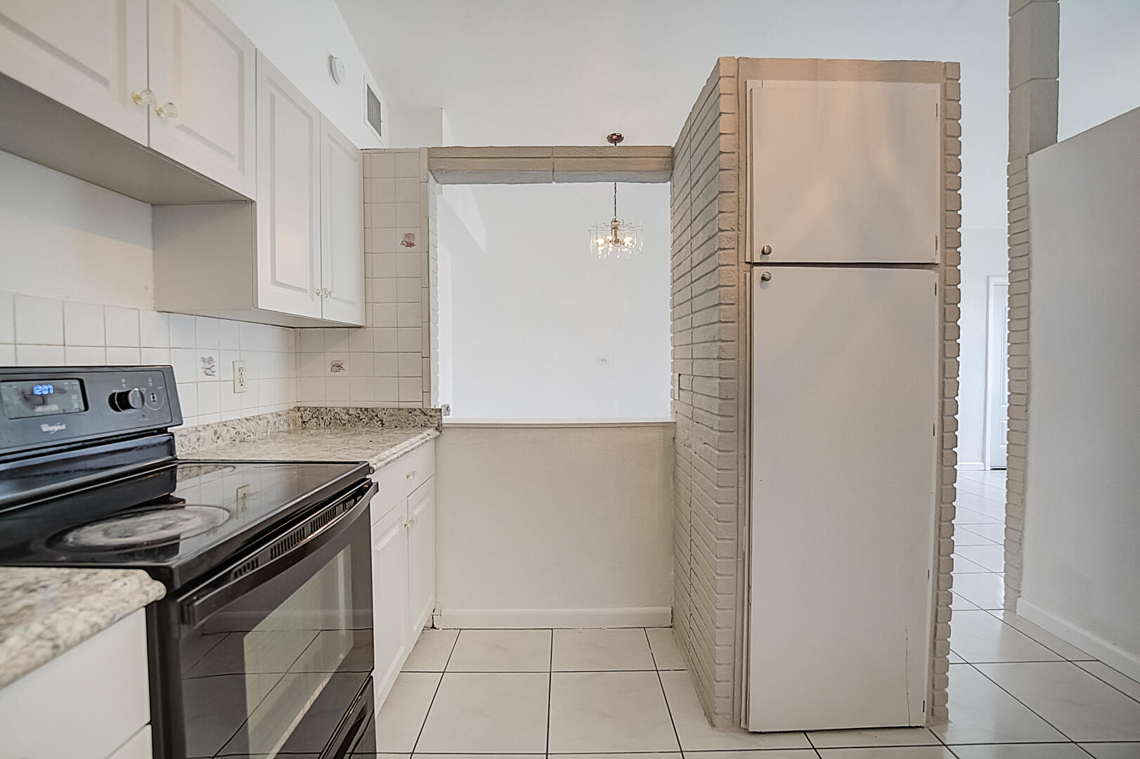 2813 Southwest 68th Terrace Miramar, FL 33023 - Photo 13 of 29 a kitchen with a stove and a refrigerator