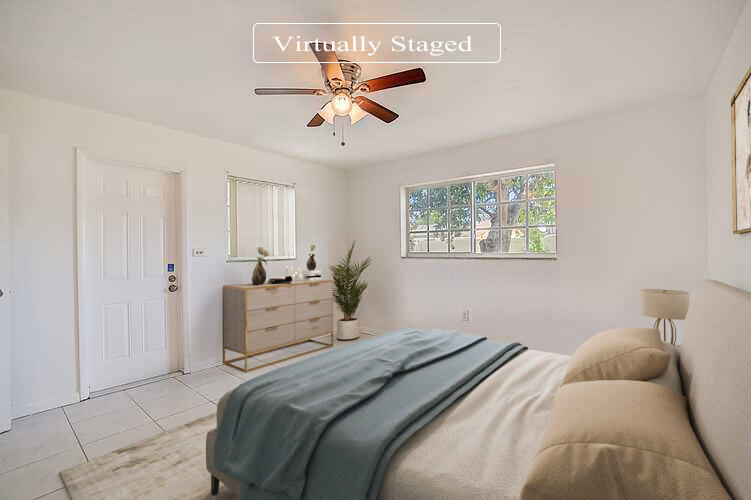 2813 Southwest 68th Terrace Miramar, FL 33023 - Photo 3 of 29 a bedroom with a large bed and a chandelier