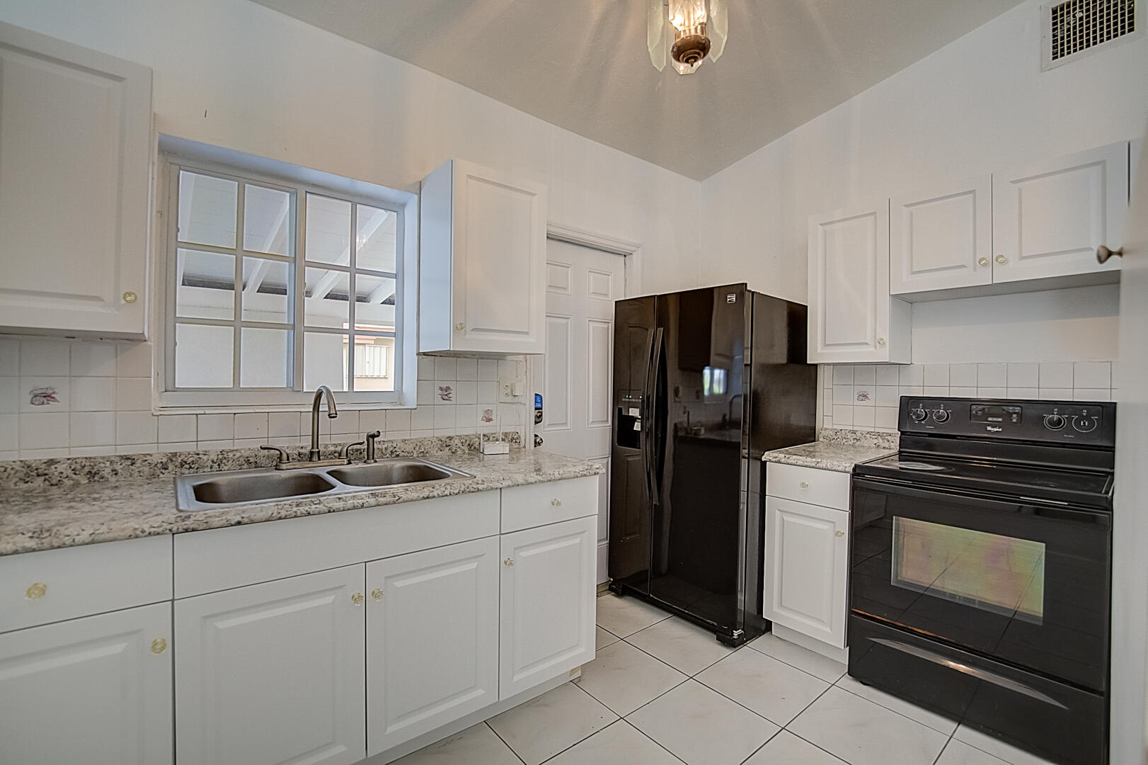 2813 Southwest 68th Terrace Miramar, FL 33023 - Photo 4 of 29 a kitchen with a sink stove and refrigerator