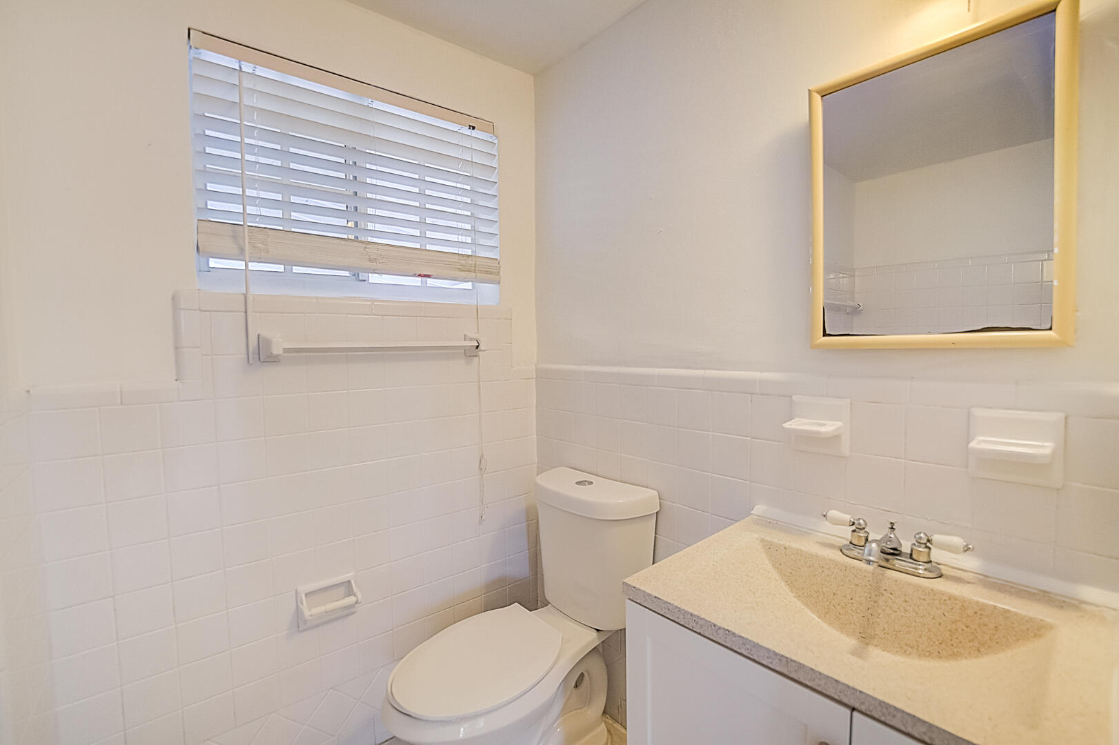 2813 Southwest 68th Terrace Miramar, FL 33023 - Photo 6 of 29 a bathroom with a sink a toilet and mirror