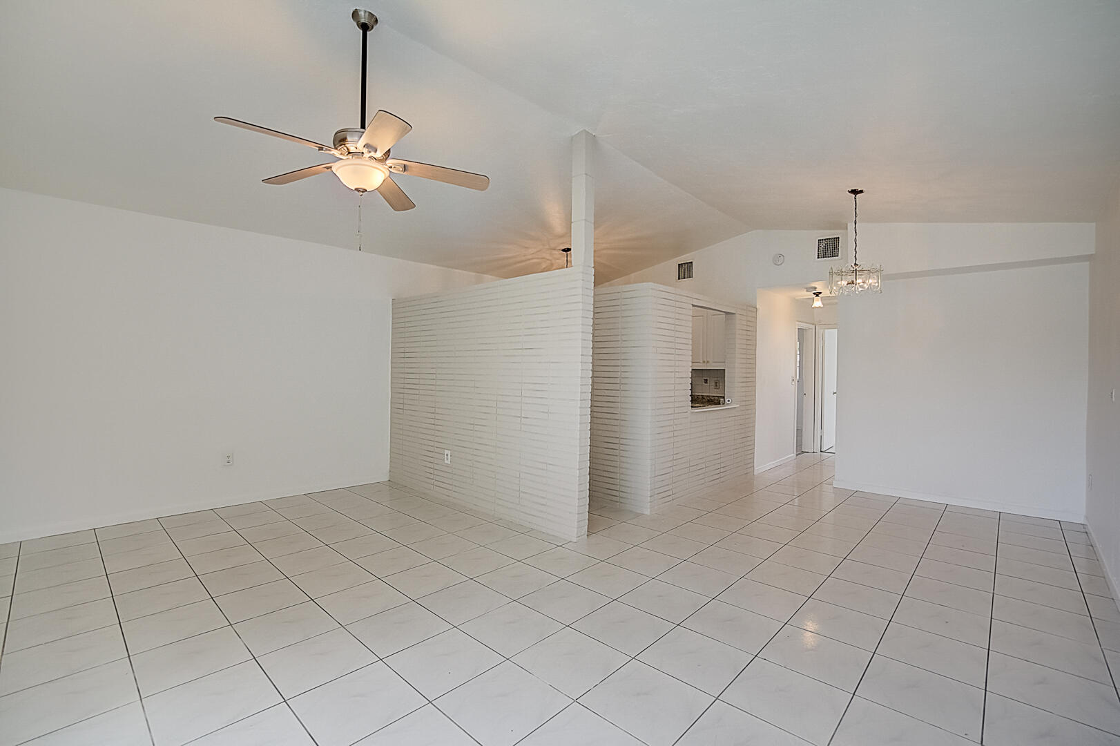 2813 Southwest 68th Terrace Miramar, FL 33023 - Photo 10 of 29 wooden floor in an empty room with a chandelier fan