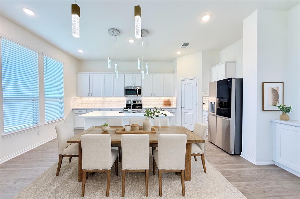 1336 Morning View Road Georgetown, TX 78628 - Photo 11 of 40 An open-concept living area boasts recessed lighting and durable wood-look flooring, creating an inviting atmosphere.