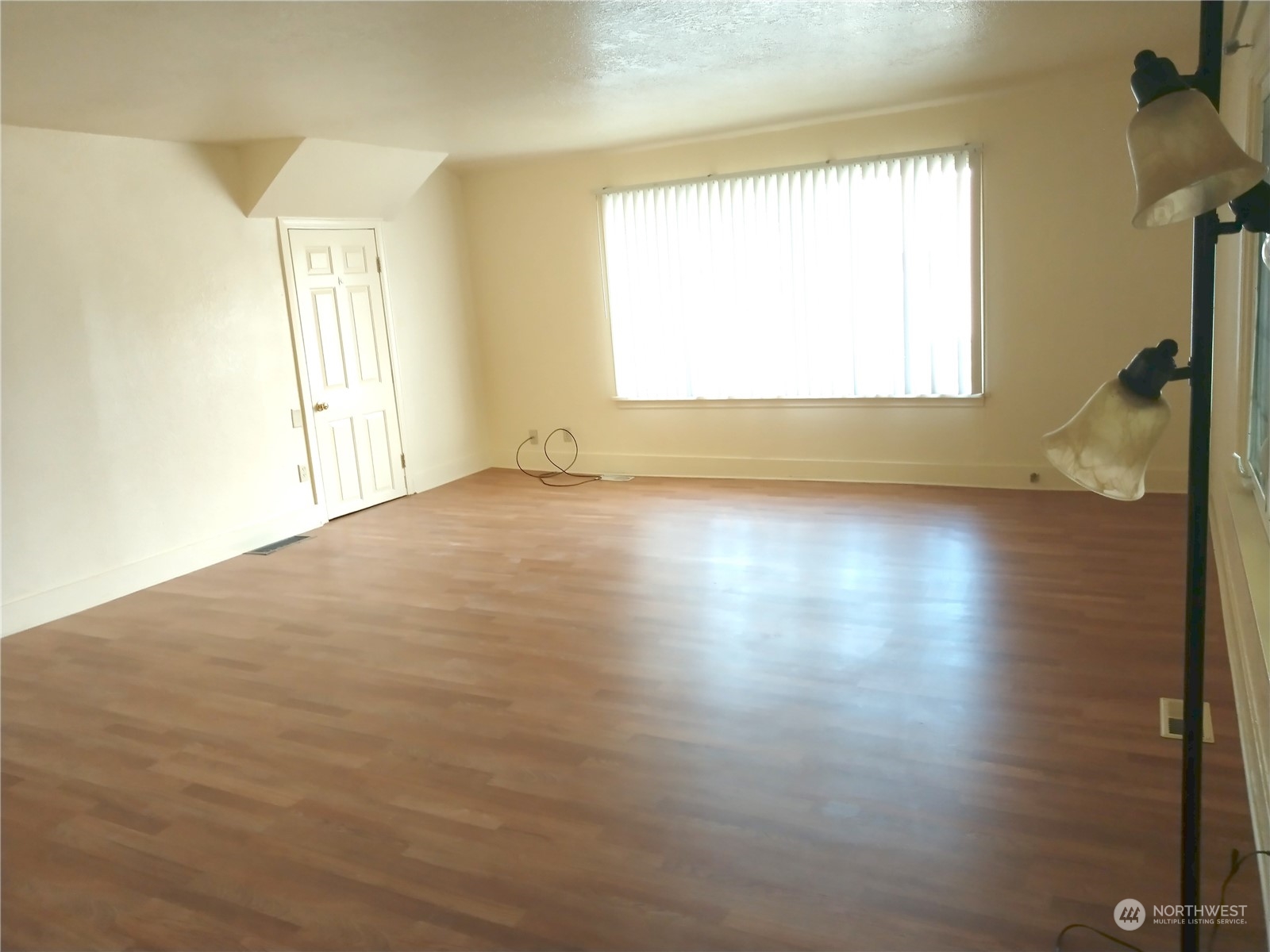 123 Factory Avenue North Renton, WA 98057 - Photo 7 of 19 an empty room with wooden floor and windows