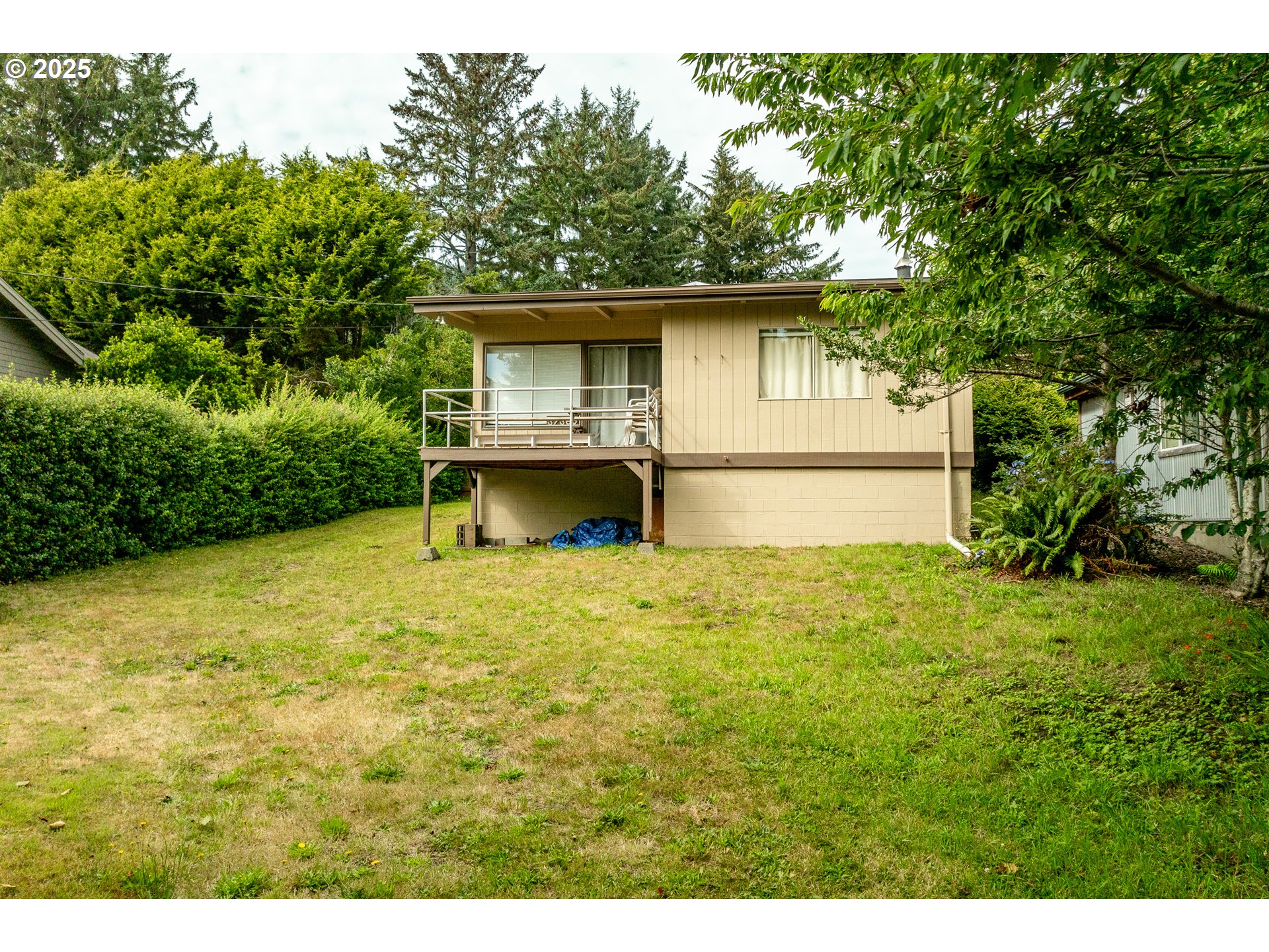 37365 4th Street Nehalem, OR 97131 - Photo 19 of 27 a view of a backyard with large trees