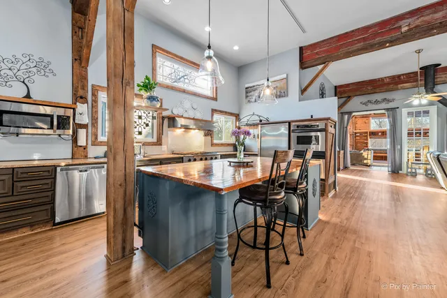a kitchen with stainless steel appliances granite countertop a sink and cabinets