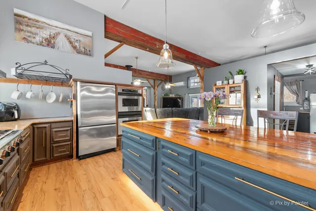 a view of a hallway with wooden floor and stairs