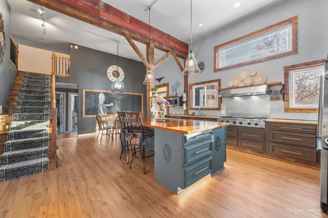 a living room with stainless steel appliances granite countertop lots of white furniture