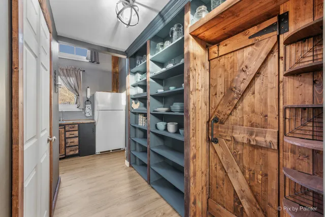 a view of a dining room with furniture large windows and wooden floor