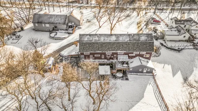 a room with lots of wooden furniture and windows