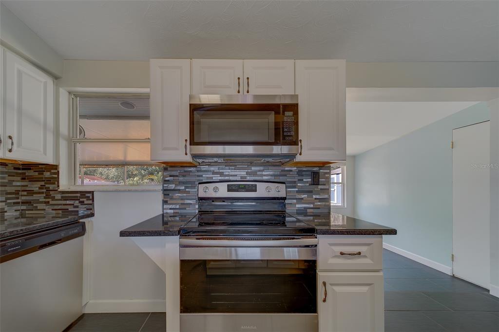 11128 116th Street Largo, FL 33778 - Photo 13 of 50 a kitchen with appliances a sink and cabinets