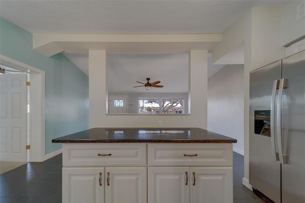 11128 116th Street Largo, FL 33778 - Photo 15 of 50 a kitchen with cabinets and stainless steel appliances