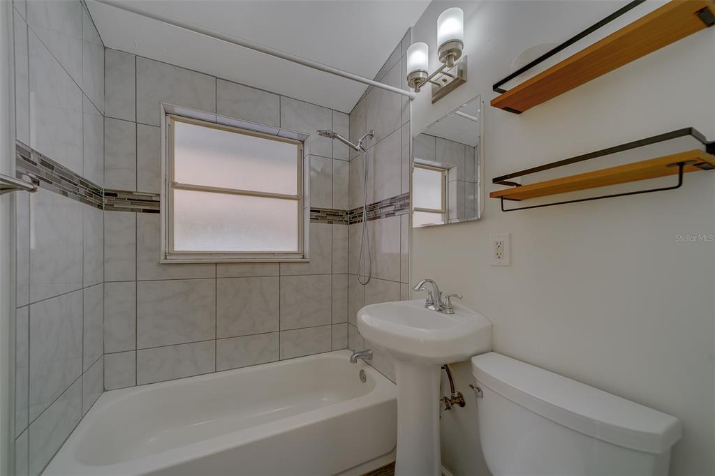 11128 116th Street Largo, FL 33778 - Photo 28 of 50 a bathroom with a sink a toilet and shower