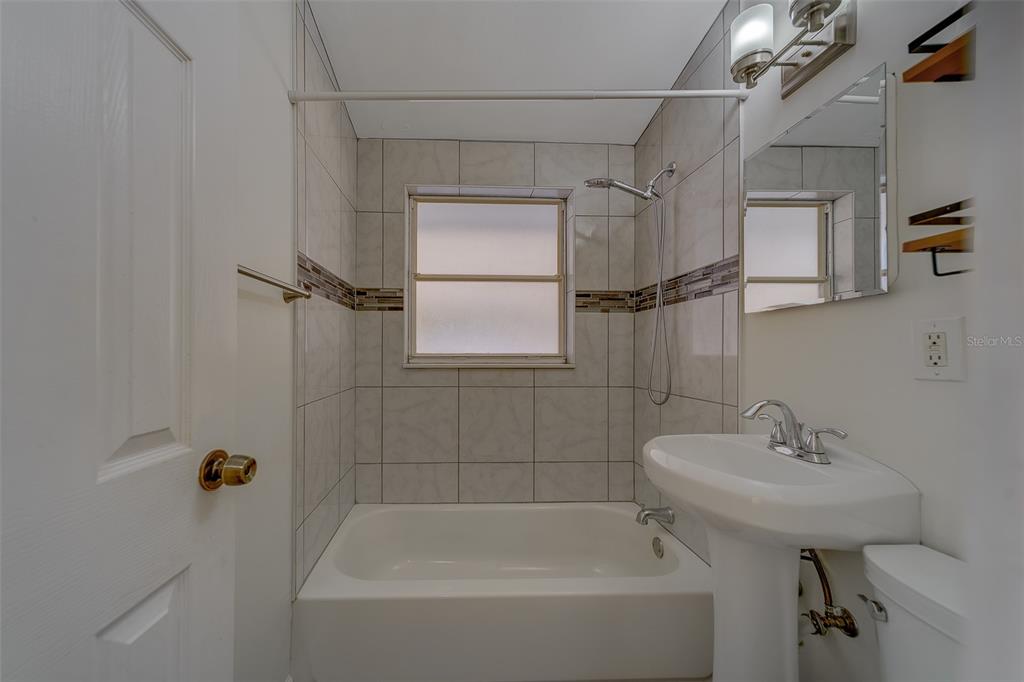 11128 116th Street Largo, FL 33778 - Photo 29 of 50 a white bath tub sitting next to a white sink