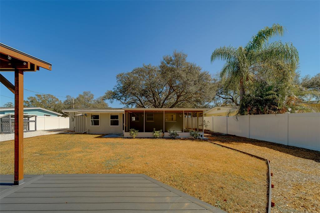 11128 116th Street Largo, FL 33778 - Photo 44 of 50 a front view of house with yard and trees in the background
