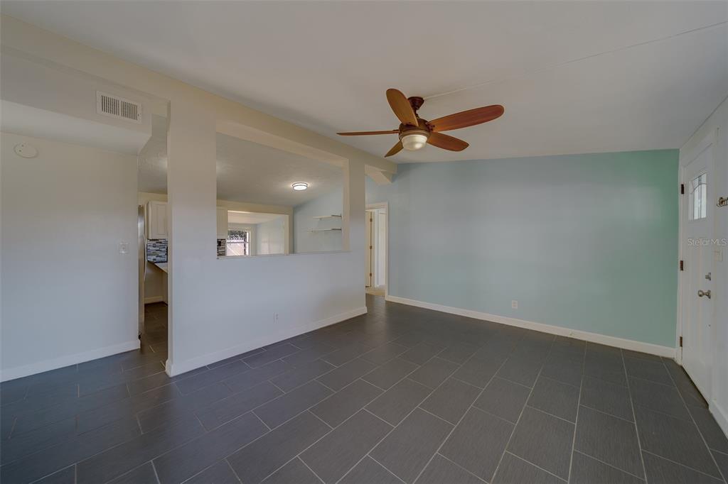 11128 116th Street Largo, FL 33778 - Photo 5 of 50 a view of a livingroom with a ceiling fan and wooden floor