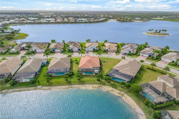 an aerial view of a house with a lake view