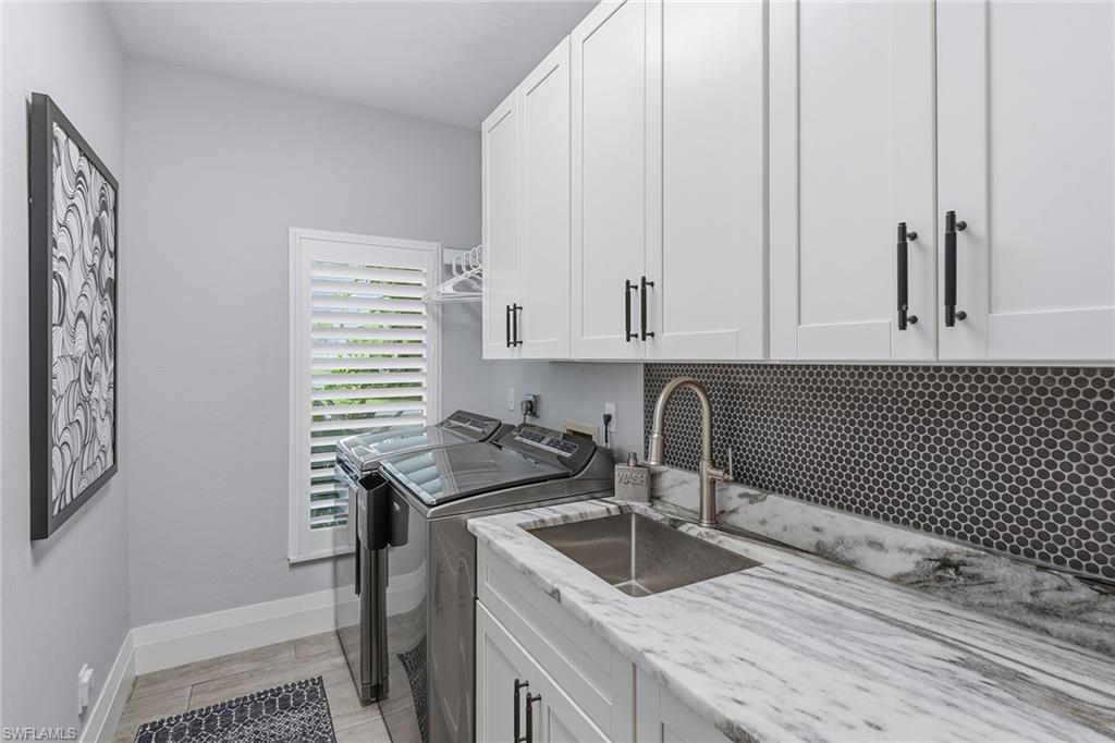 14685 Kelson Circle Naples, FL 34114 - Photo 18 of 50 a kitchen with granite countertop a sink a stove and cabinets