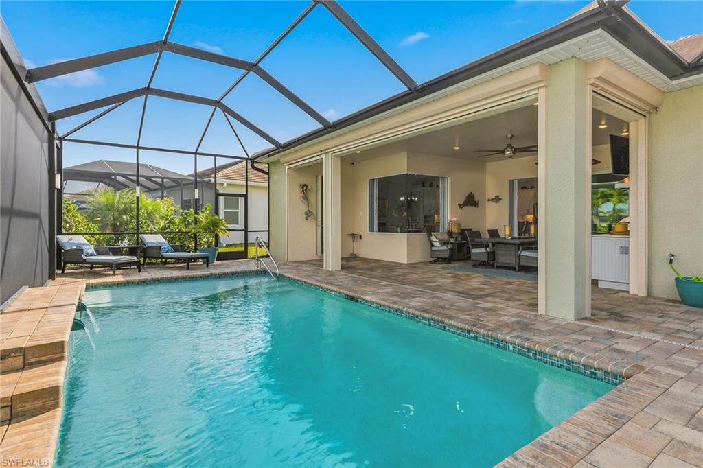 14685 Kelson Circle Naples, FL 34114 - Photo 26 of 50 a backyard of a house with yard table and chairs