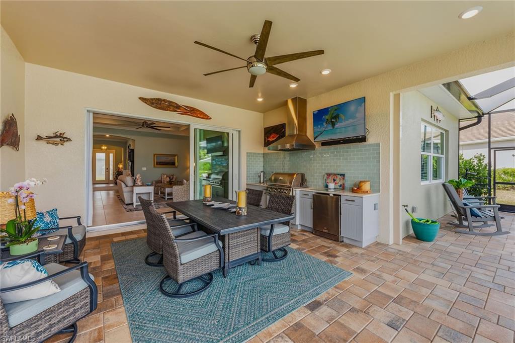 14685 Kelson Circle Naples, FL 34114 - Photo 27 of 50 a living room with furniture a dining table and paintings on the wall