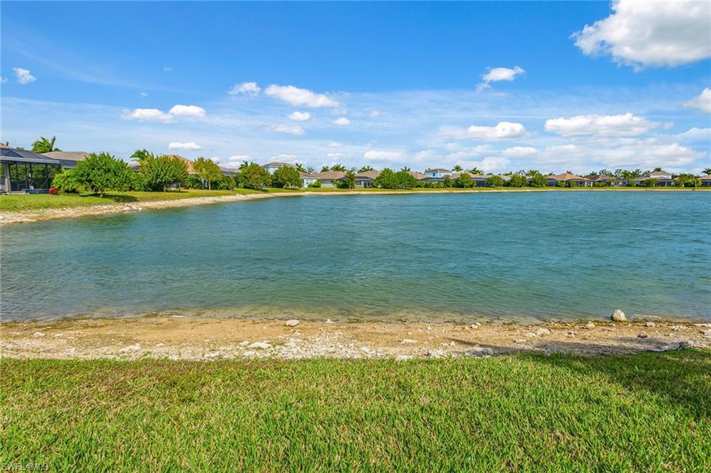 14685 Kelson Circle Naples, FL 34114 - Photo 28 of 50 a view of a lake with houses in the back