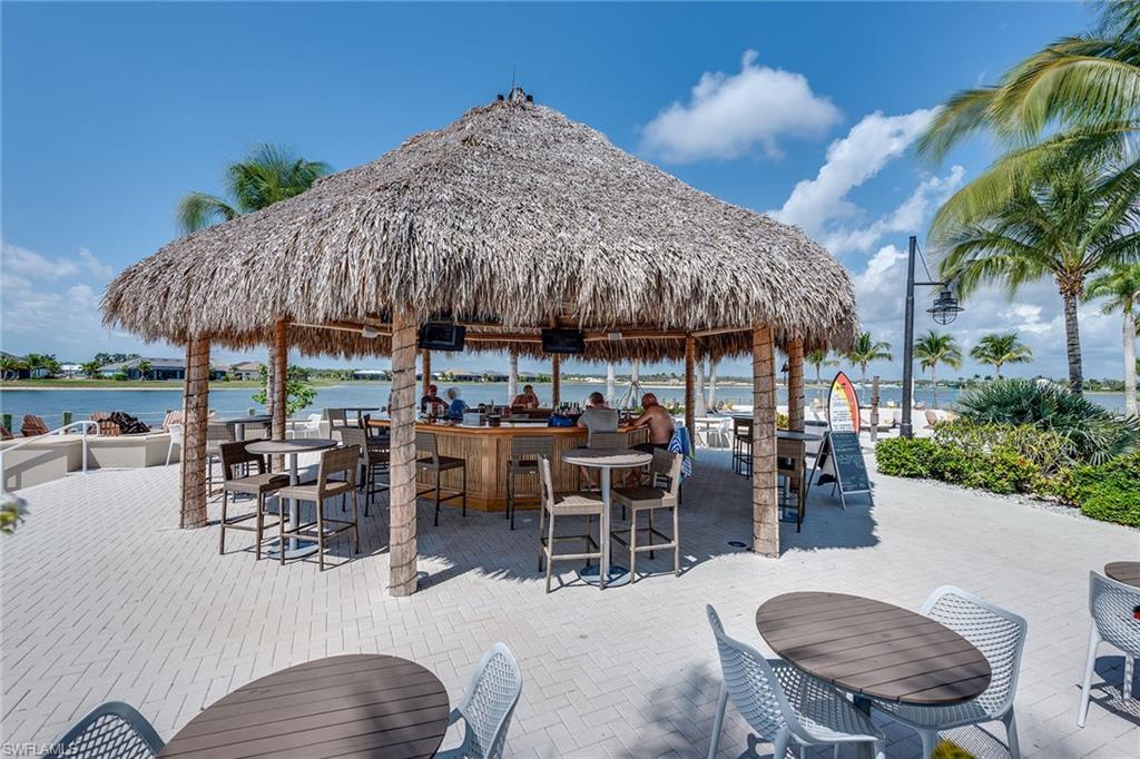 14685 Kelson Circle Naples, FL 34114 - Photo 40 of 50 a patio with a table and chairs