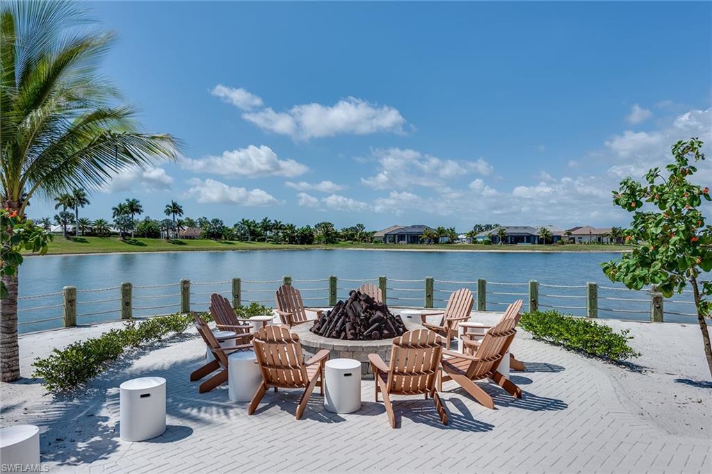 14685 Kelson Circle Naples, FL 34114 - Photo 42 of 50 a view of a lake with table and chairs