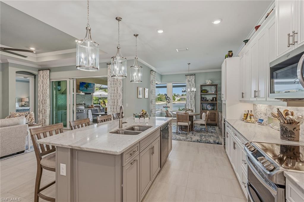 14685 Kelson Circle Naples, FL 34114 - Photo 5 of 50 a kitchen with counter top space a sink appliances and cabinets
