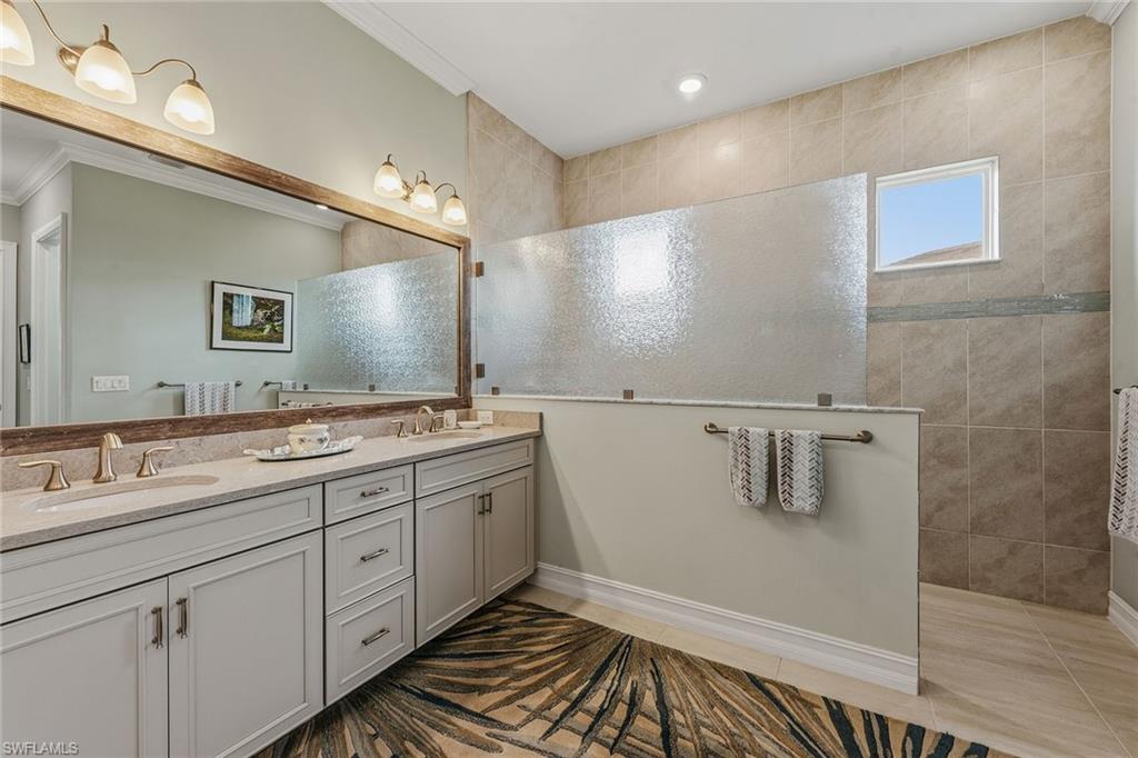 14685 Kelson Circle Naples, FL 34114 - Photo 9 of 50 a bathroom with a double vanity sink and mirror