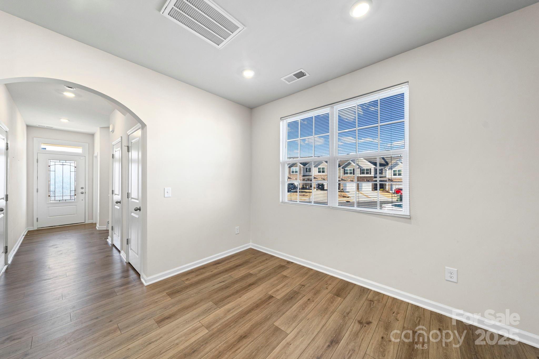 5044 Moss Pine Way Tega Cay, SC 29708 - Photo 12 of 40 a view of a big room with wooden floor and a window
