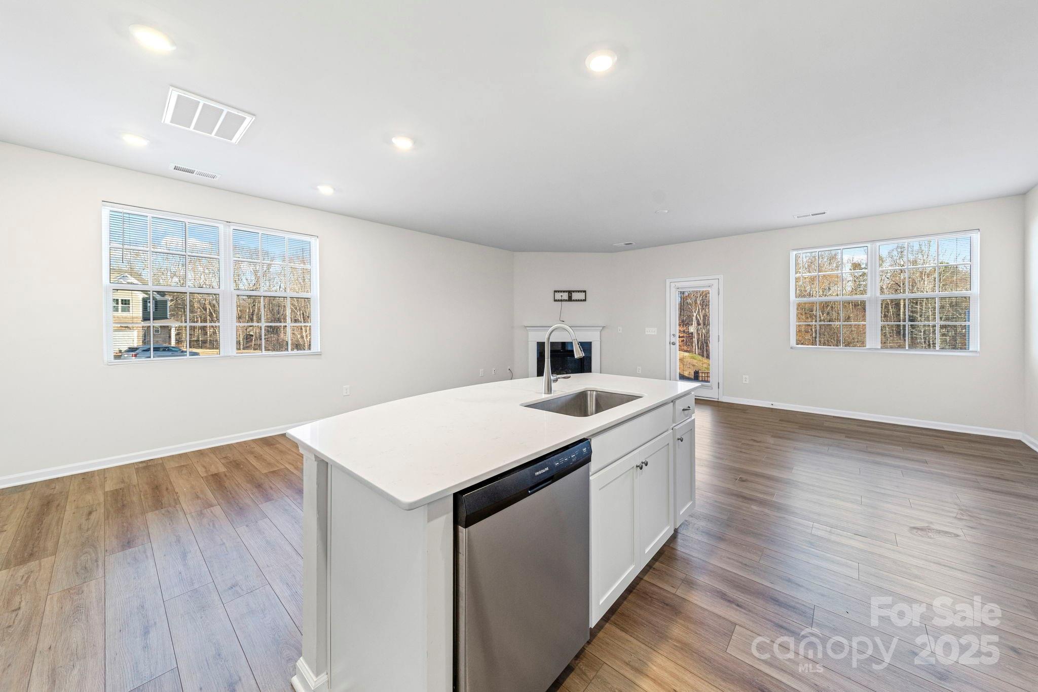 5044 Moss Pine Way Tega Cay, SC 29708 - Photo 17 of 40 a large white kitchen with sink and wooden floor