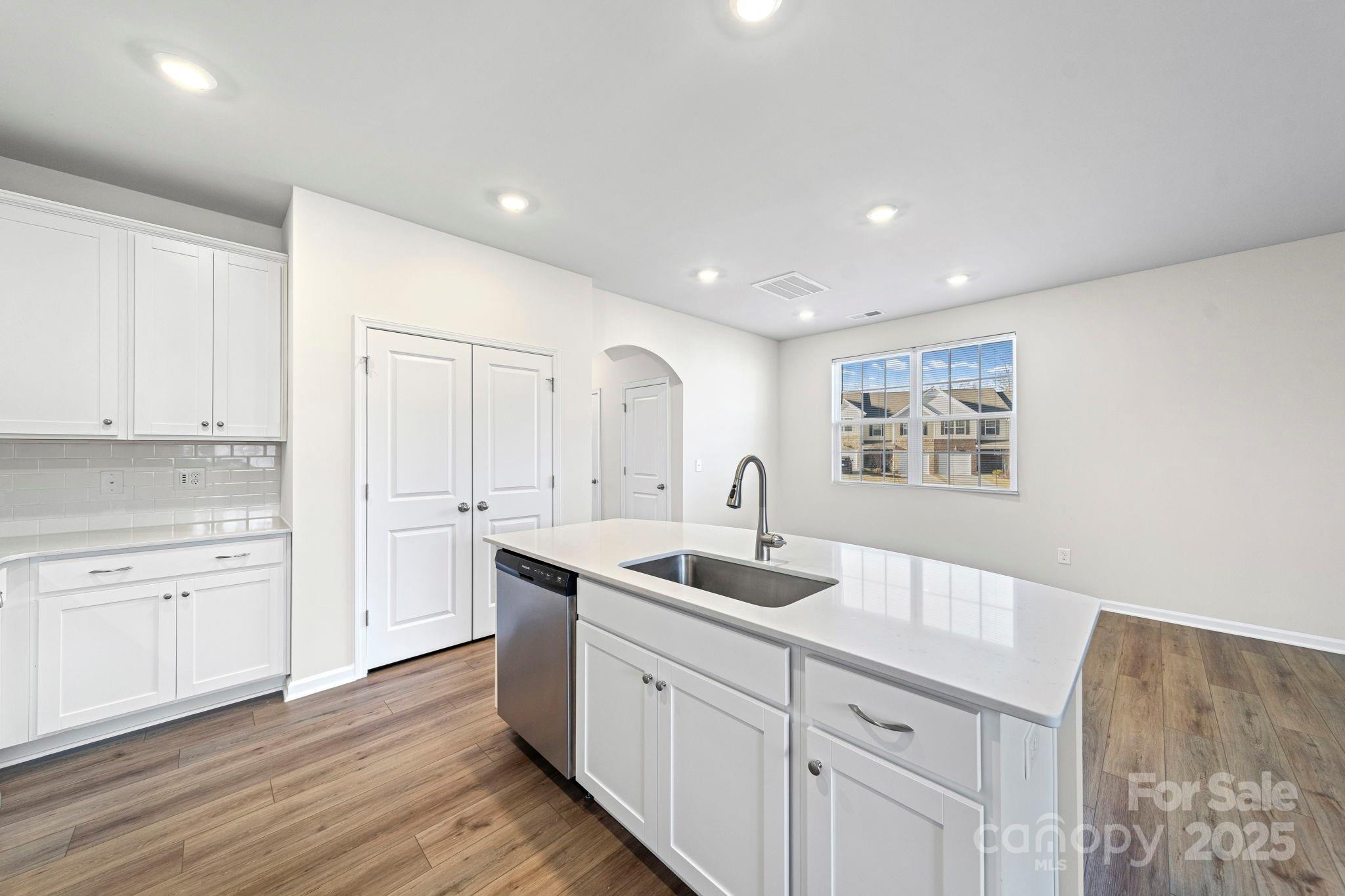 5044 Moss Pine Way Tega Cay, SC 29708 - Photo 18 of 40 a kitchen with sink cabinets and wooden floor