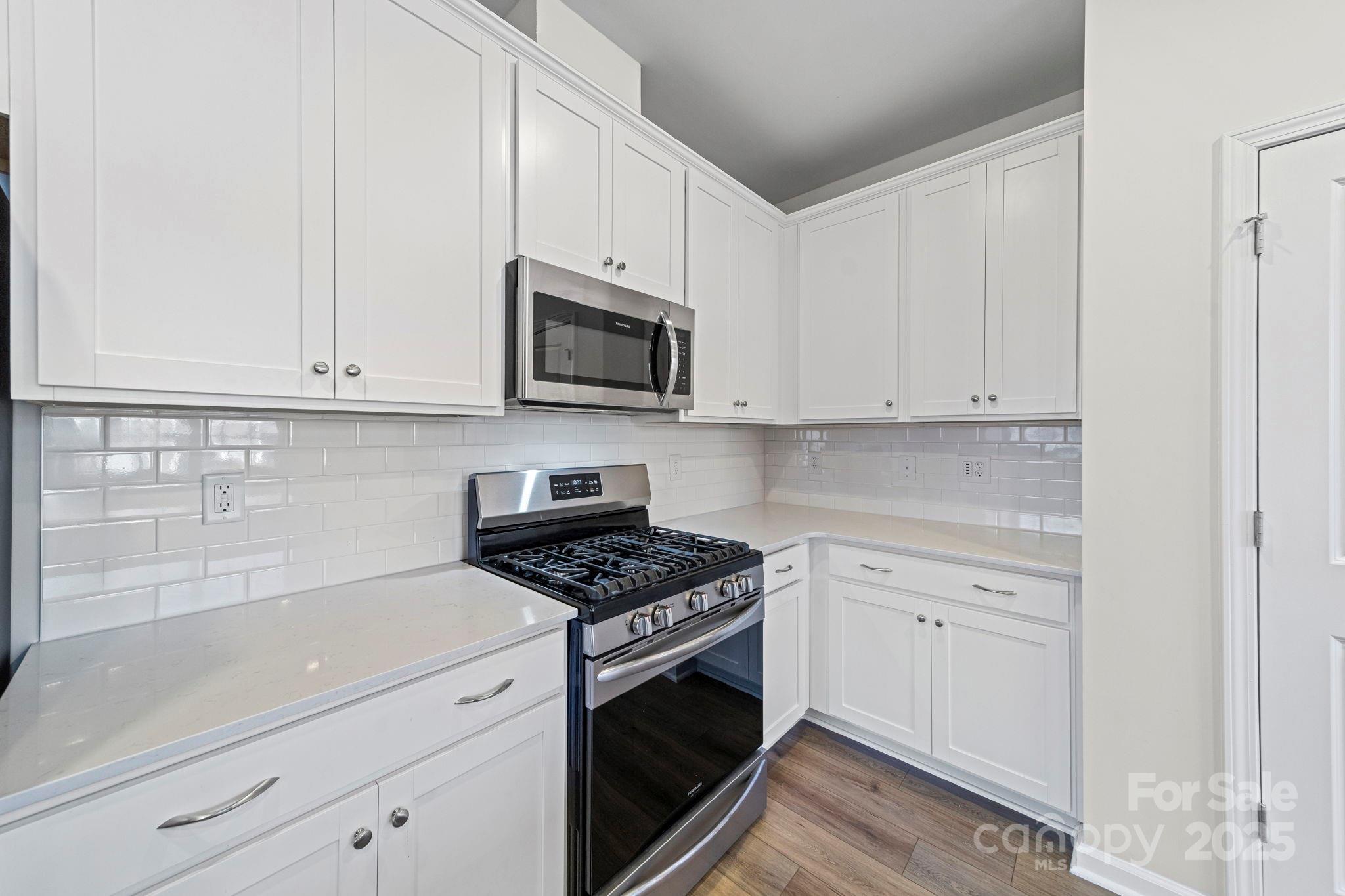 5044 Moss Pine Way Tega Cay, SC 29708 - Photo 19 of 40 a kitchen with white cabinets and appliances