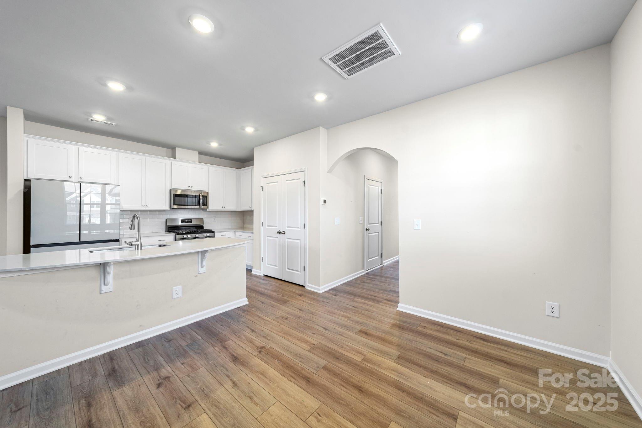 5044 Moss Pine Way Tega Cay, SC 29708 - Photo 20 of 40 a large kitchen with stainless steel appliances granite countertop a refrigerator and a stove top oven