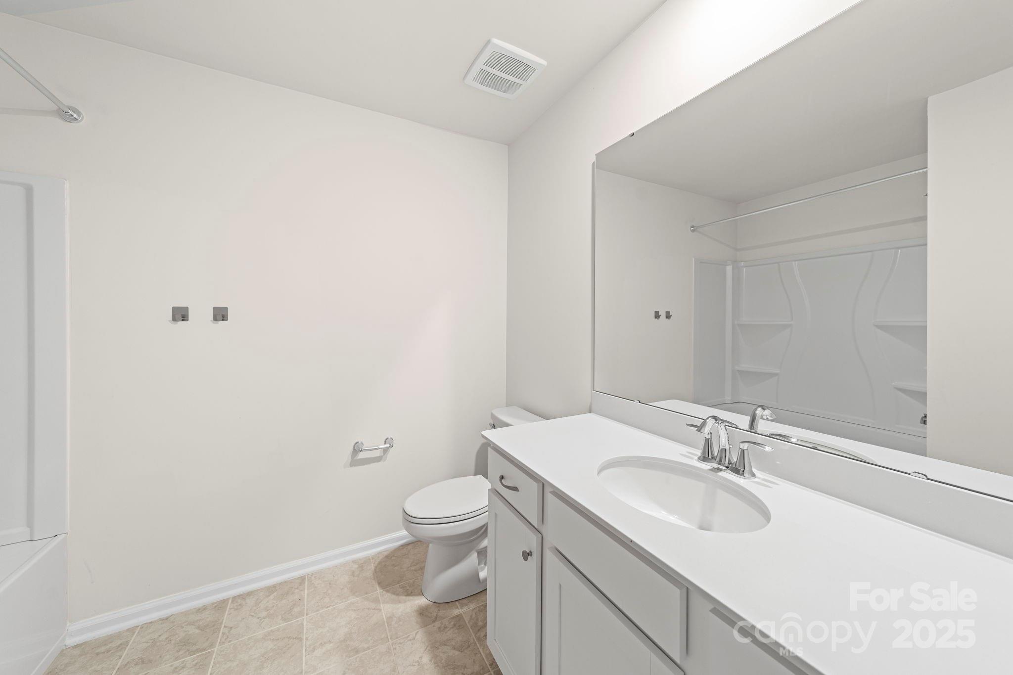 5044 Moss Pine Way Tega Cay, SC 29708 - Photo 29 of 40 a bathroom with a toilet sink and mirror