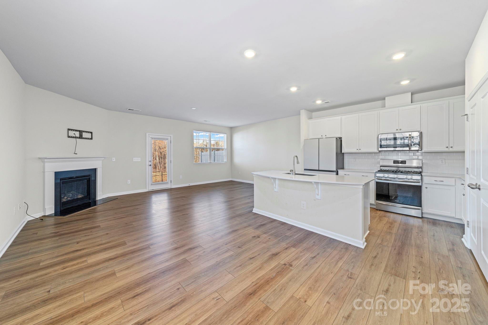 5044 Moss Pine Way Tega Cay, SC 29708 - Photo 3 of 40 a view of kitchen with cabinets stove top oven and refrigerator